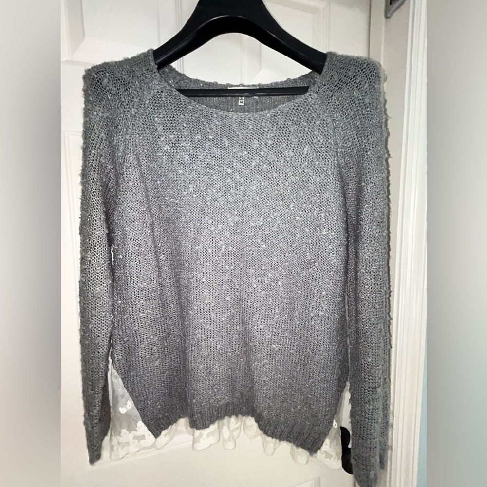 Gray sweater with lace accent.